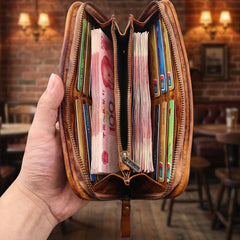 Black leather long wallet with wristlet, lifestyle shot with jeans