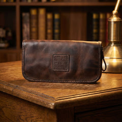 Vintage distressed leather wallet with detachable wristlet on wood