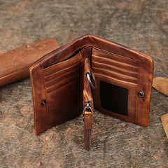 Open brown leather bifold wallet showing card slots, ID window and zip coin pocket