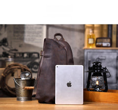 Large leather sling bag - side profile showing triangle silhouette