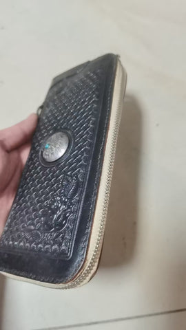 Black tooled leather men's zipper long wallet with a chain strap, featuring a detailed embossed pattern and a metal zipper.