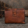 Cognac brown leather billfold wallet with snap strap and top zipper, front view