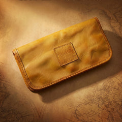 Black full-grain leather zip-around long wallet with antique brass zipper