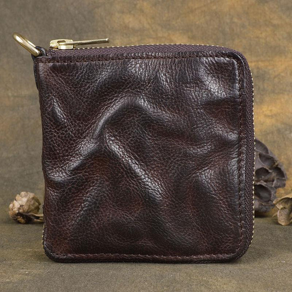 Handmade wrinkled dark brown leather billfold wallet with zip-around closure, front view