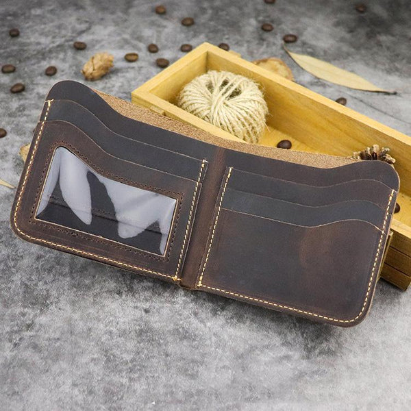 Open dark brown distressed leather billfold wallet with transparent license window and card slots