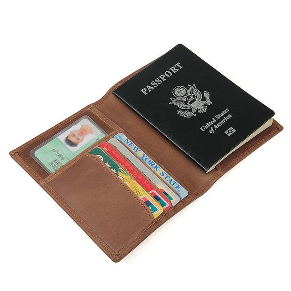 Open brown leather passport travel wallet with passport, cards and license inside