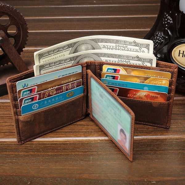 Open vintage brown leather billfold wallet with cards, license window and dollar bills