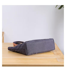 bottom of gray canvas crossbody tote